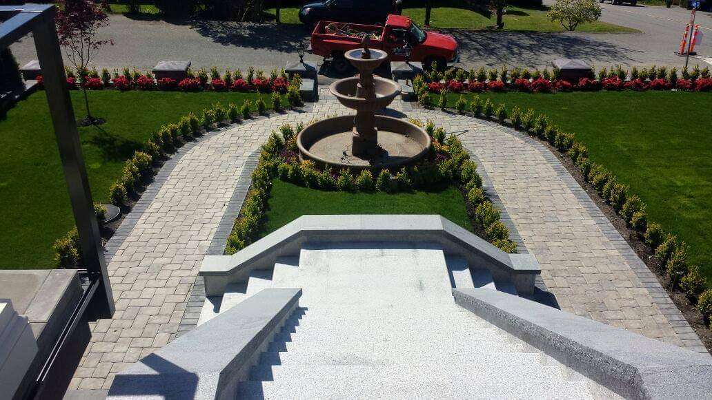 Fountain surrounded by inlaid blocks and retaining wall